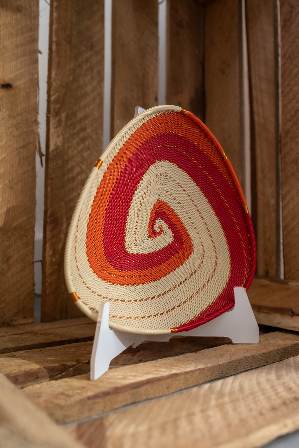 a white, red and orange telephone wire handmade bowl